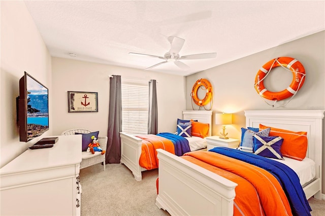 carpeted bedroom featuring a textured ceiling and ceiling fan