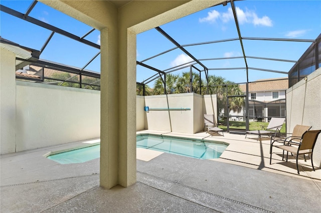 view of swimming pool featuring a lanai and a patio area