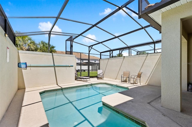 view of swimming pool with a lanai and a patio area