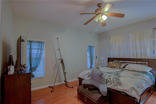 bedroom with ceiling fan and light hardwood / wood-style flooring