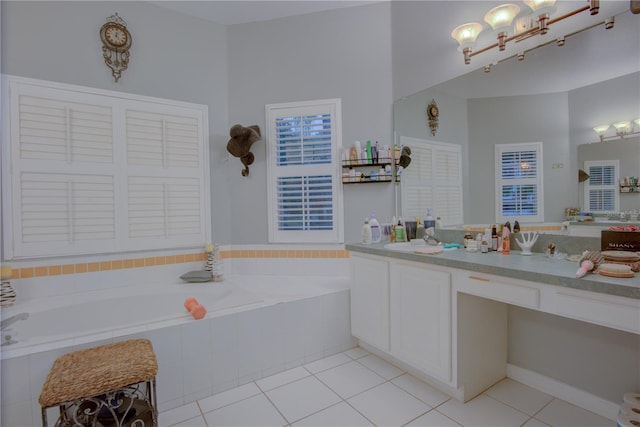 bathroom featuring vanity, tiled tub, and tile patterned floors