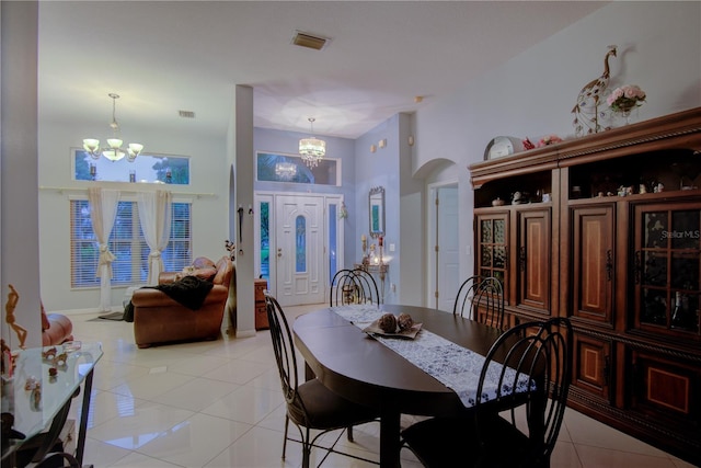 tiled dining space with a notable chandelier