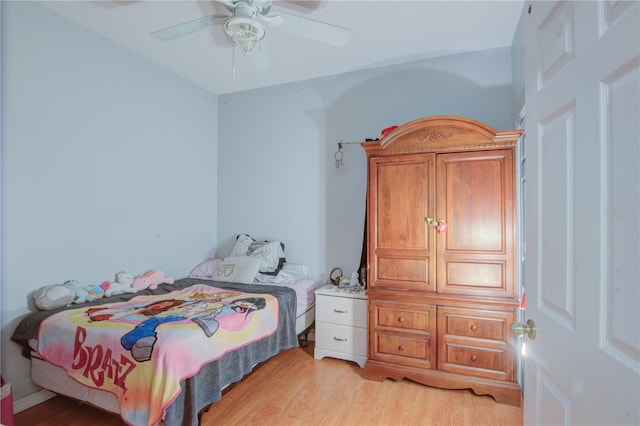 bedroom with light hardwood / wood-style floors and ceiling fan