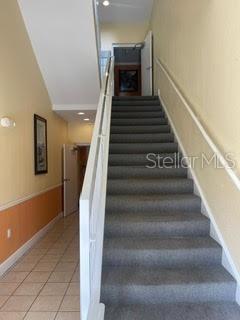 stairs with light tile patterned floors