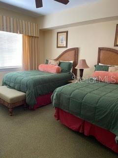 carpeted bedroom featuring ceiling fan