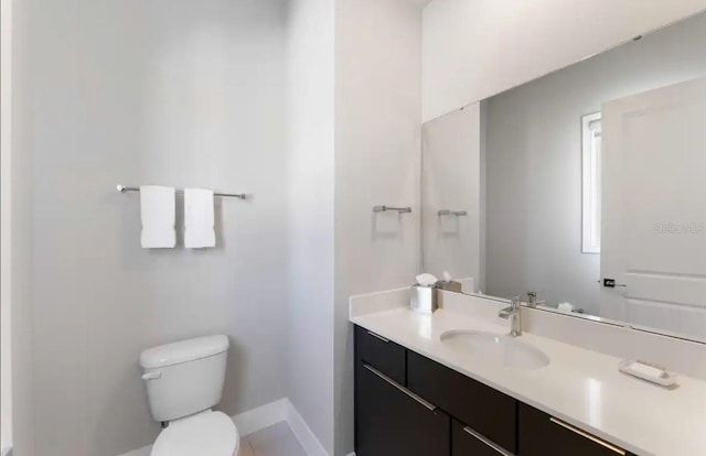 bathroom with toilet and vanity