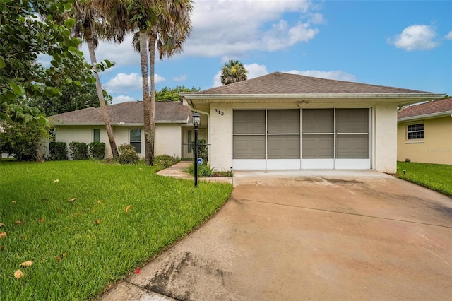 ranch-style house featuring a garage and a front yard