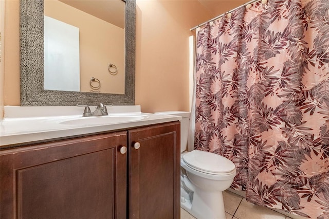 bathroom featuring vanity, tile patterned flooring, and toilet