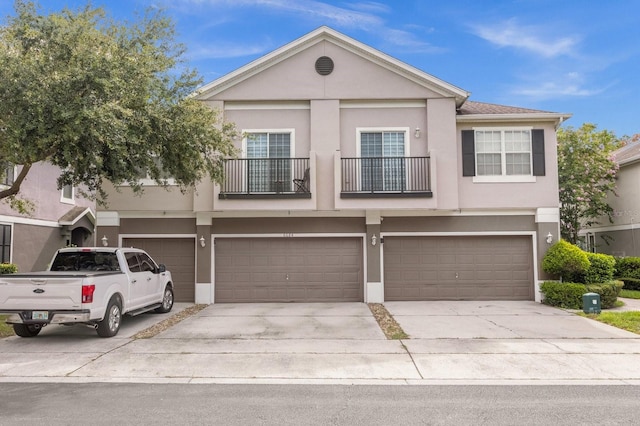 view of front of home with a balcony and a garage