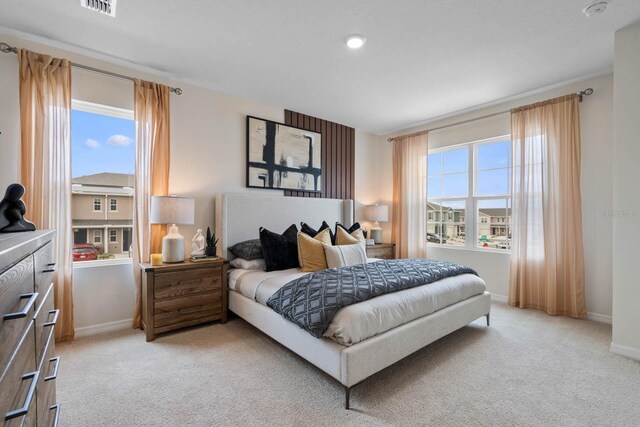 bedroom featuring light colored carpet