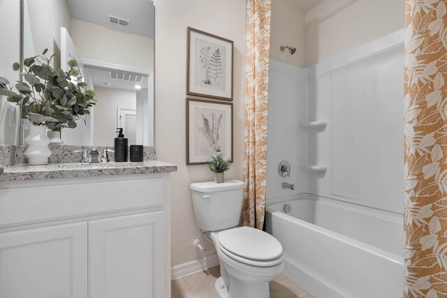 full bathroom featuring tile patterned flooring, shower / bath combo, toilet, and vanity