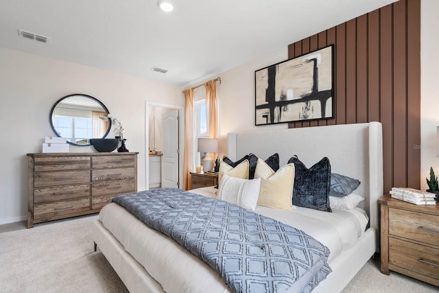 bedroom with light carpet and multiple windows