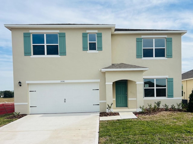 view of front facade with a garage and a front lawn