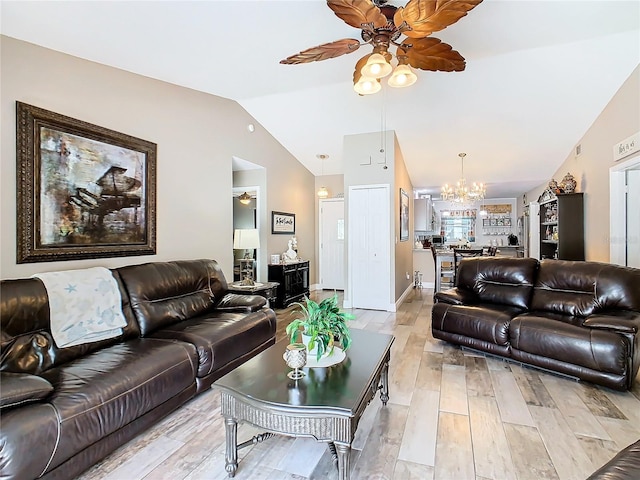 living room with vaulted ceiling, light hardwood / wood-style flooring, and ceiling fan with notable chandelier