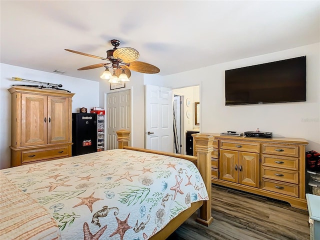 bedroom featuring ceiling fan, a closet, and dark hardwood / wood-style floors