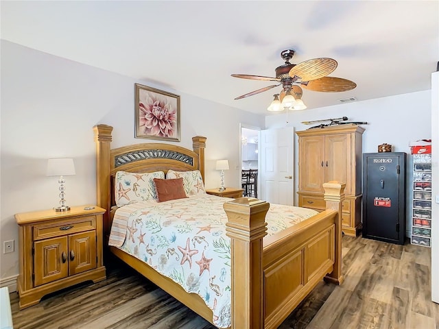 bedroom with dark hardwood / wood-style flooring and ceiling fan