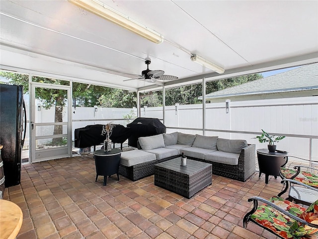 sunroom featuring ceiling fan