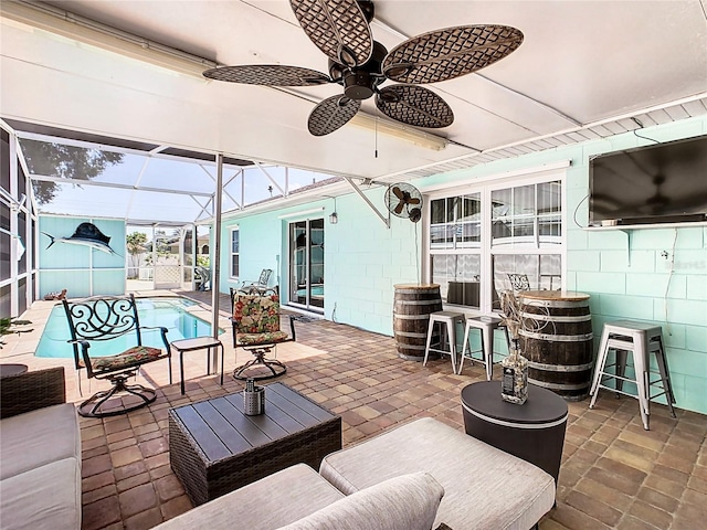 view of patio with glass enclosure and an outdoor hangout area