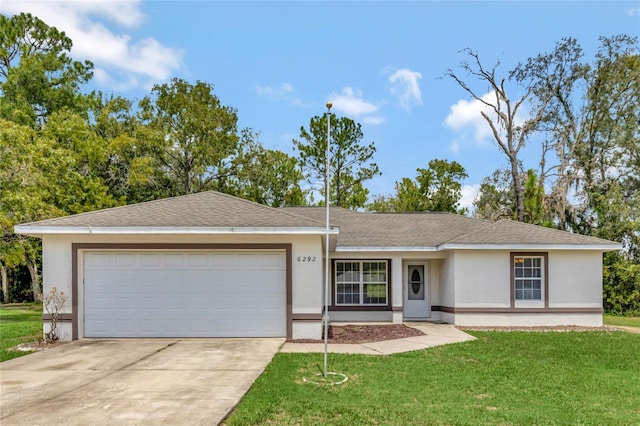 ranch-style home with a garage and a front yard