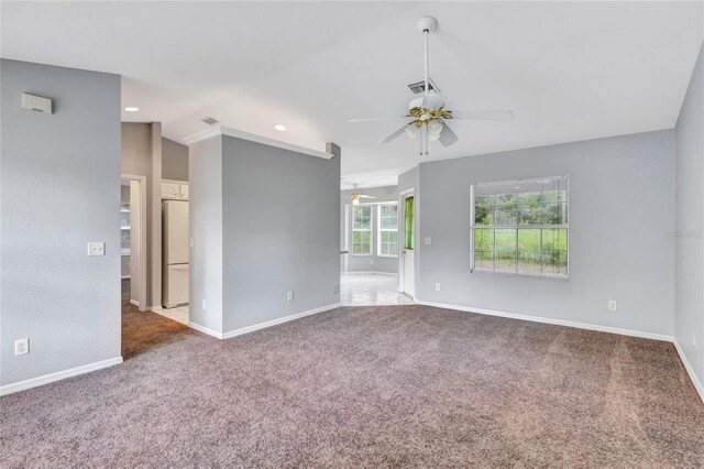 spare room featuring carpet, ceiling fan, and lofted ceiling