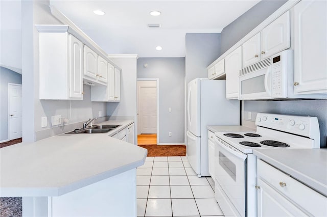 kitchen featuring sink, white cabinetry, light tile patterned floors, and white appliances