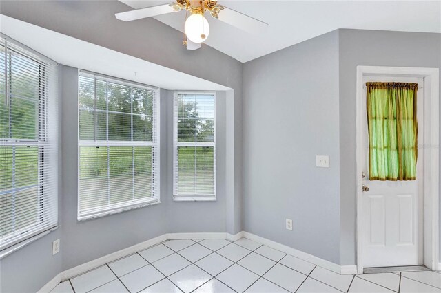 tiled spare room with ceiling fan