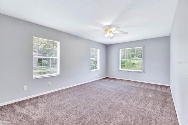 carpeted empty room featuring ceiling fan