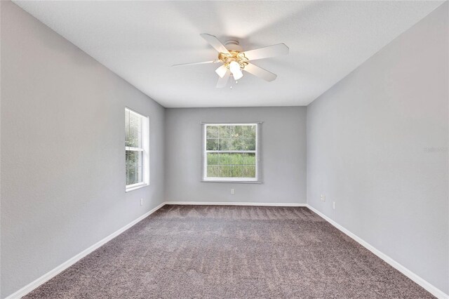 empty room with carpet floors and ceiling fan