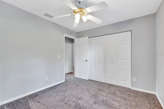 unfurnished bedroom with carpet, ceiling fan, and a closet