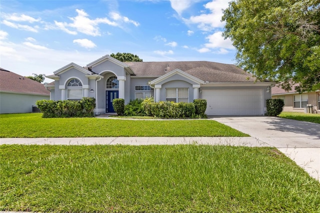 single story home with a garage and a front yard