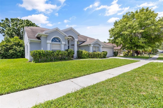 view of front of property with a garage and a front yard