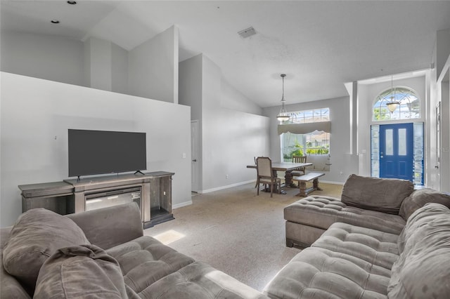 living room featuring light carpet and high vaulted ceiling