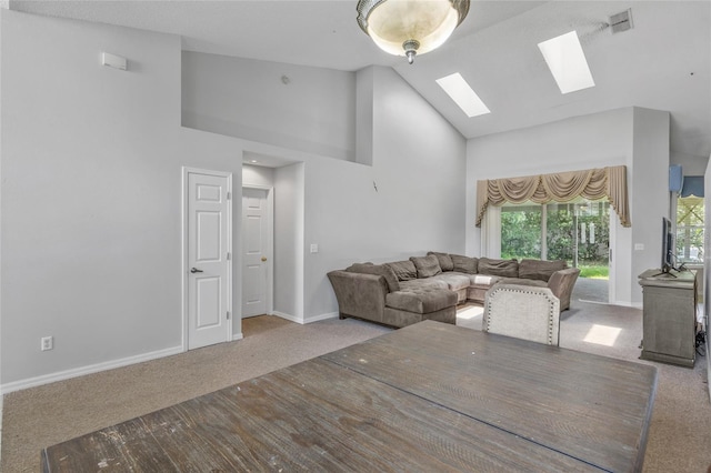 living room featuring a skylight, light colored carpet, and high vaulted ceiling