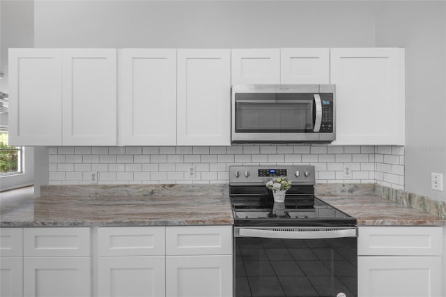 kitchen with white cabinets and appliances with stainless steel finishes