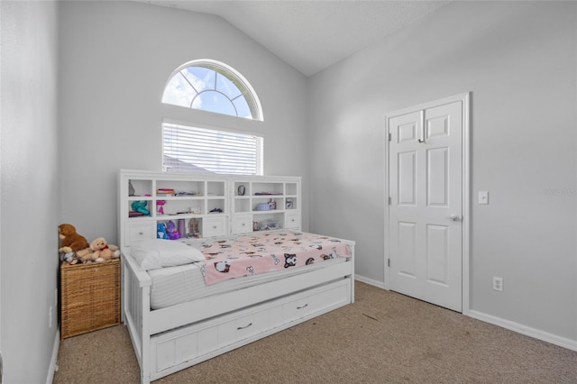 bedroom featuring lofted ceiling and light colored carpet