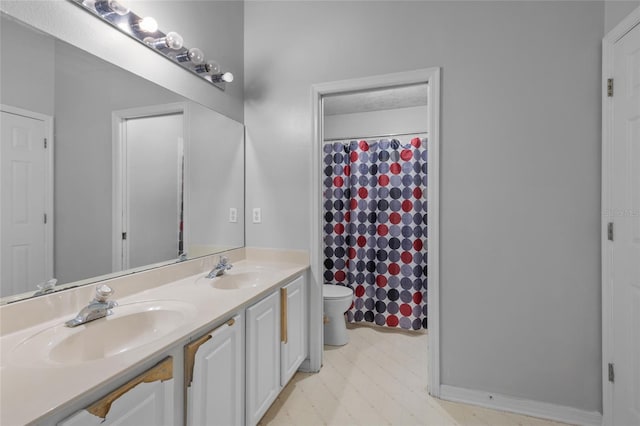 bathroom with toilet, a shower with shower curtain, and vanity