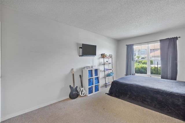 bedroom with carpet and a textured ceiling