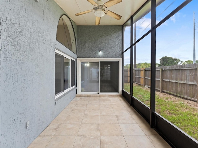 unfurnished sunroom with ceiling fan