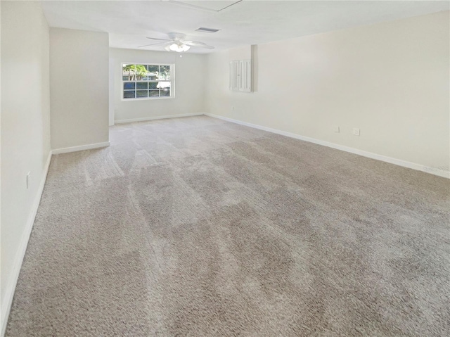 empty room with light colored carpet and ceiling fan