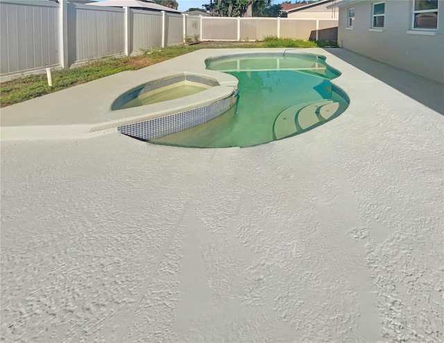 view of pool featuring an in ground hot tub