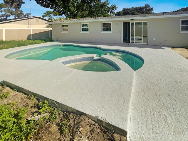 view of swimming pool featuring an in ground hot tub