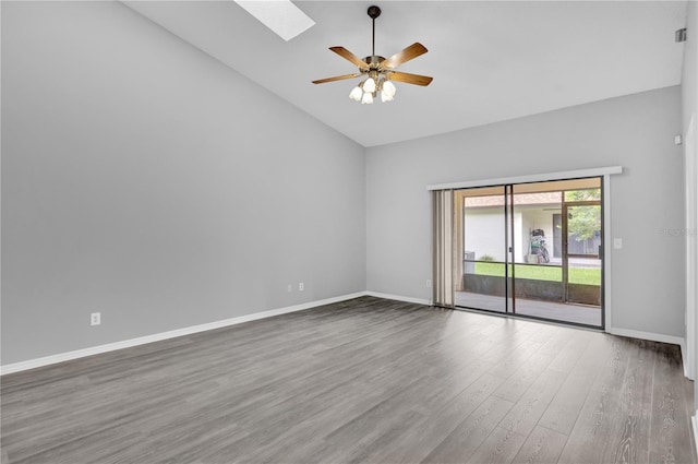 spare room featuring hardwood / wood-style flooring, high vaulted ceiling, ceiling fan, and a skylight