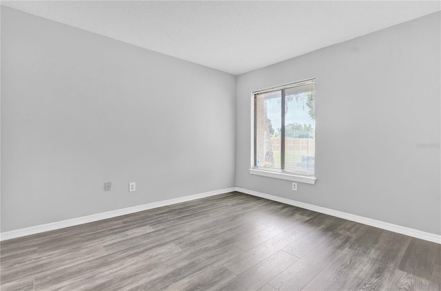 unfurnished room with wood-type flooring