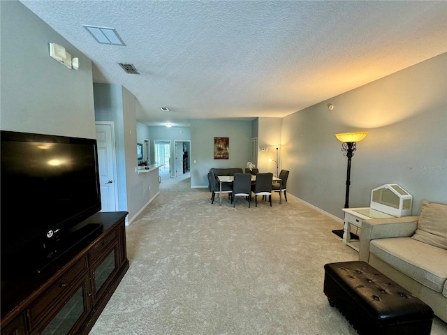 carpeted living room featuring a textured ceiling