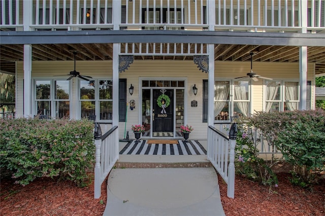 entrance to property featuring a balcony and ceiling fan