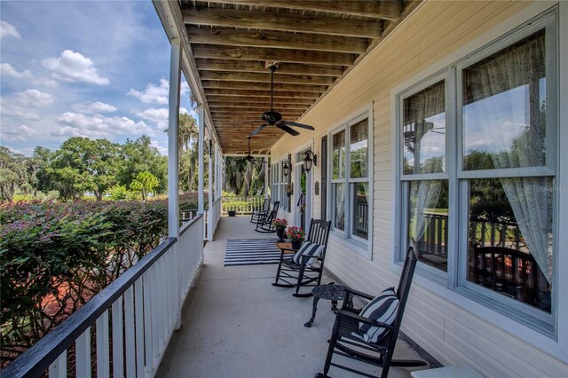 balcony featuring a porch and ceiling fan