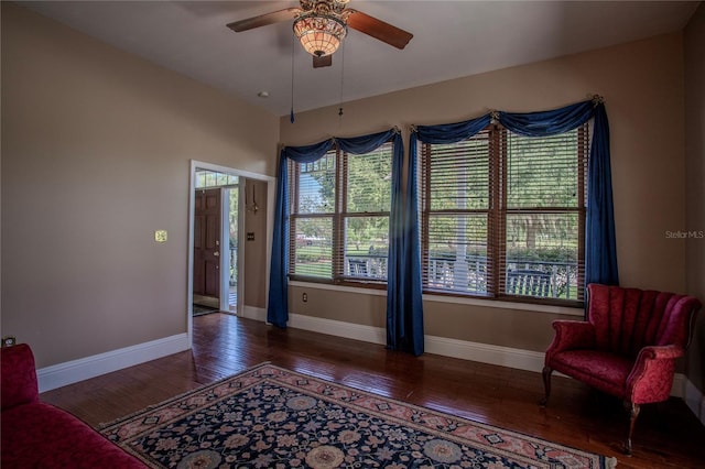 living area featuring hardwood / wood-style floors and ceiling fan