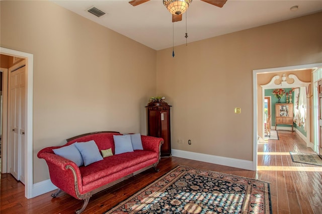 living room with ceiling fan and wood-type flooring