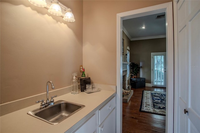 bathroom with hardwood / wood-style flooring, vanity, and ornamental molding