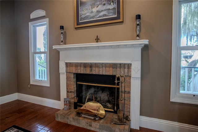 details featuring a brick fireplace and hardwood / wood-style floors